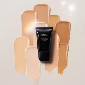 Shiny black tube centered against various shades of foundation texture.