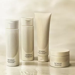 Scalp and hair care products lined up on a glossy surface.