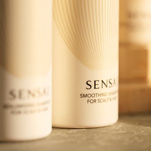 Focus on Volumising Shampoo; the other bottle is softly out of focus