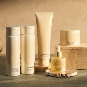 Hair care items arranged on a beige background, some displayed on blocks