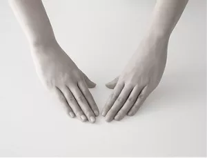 Two hands positioned palm down, prepared to start a skincare routine