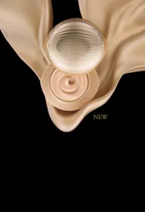 Ultimate The Foundation jar open with silky foundation swirl on gold drape background