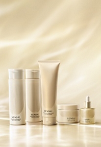 Hair care line displayed on a soft golden-beige backdrop in warm lighting