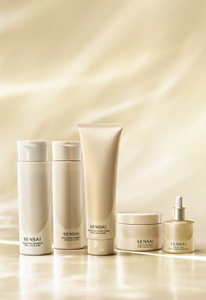 Hair care line displayed on a soft golden-beige backdrop in warm lighting
