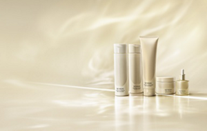 Hair care line displayed on a soft golden-beige backdrop in warm lighting