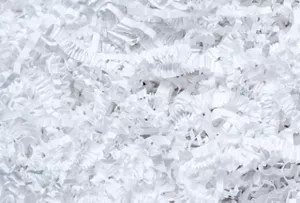 Gros plan d’une multitude de copeaux blancs identifiés comme matériaux non recyclables.