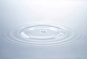 Close-up image of water with ripples and reflections.