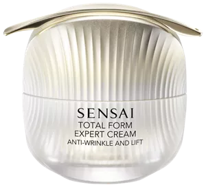 Goldener Spatel auf der Total Form Expert Cream liegend.