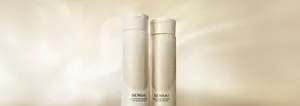 Volumising Shampoo and Smoothing Shampoo bottles in front of a beige background