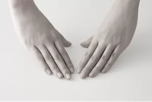 Two hands positioned palm down, prepared to start a skincare routine.