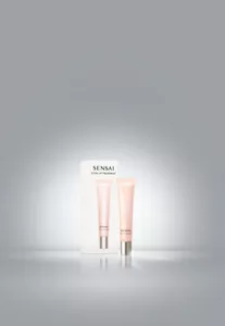 Total Lip Treatment tube in soft pink with twist cap placed in front of white box