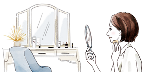 手鏡を見る女性のイメージ画像