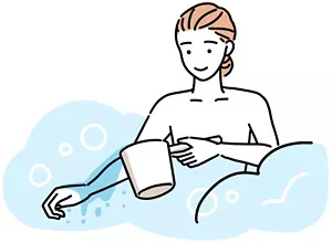 湯船に入る前にかけ湯をしている女性のイラストイメージ
