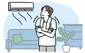 冷房に当たり寒そうにしている男性イラストイメージ