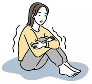 冷え症で体を丸めて震えている女性のイラストイメージ