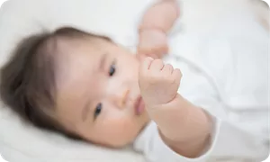 自分の手を見つめる赤ちゃん