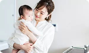 赤ちゃんをげっぷの姿勢であやすママ