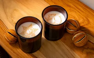 Image of Molton Brown candles decorated with snowflake and holly