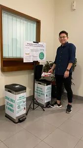 A male Kao Indonesia employee throws away calendar trash in the Bring Back to Care and Donate campaign