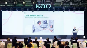 a conference stage featuring a large screen titled “Care Within Reach,” focused on advancing women’s health in Vietnam’s industrial zones.