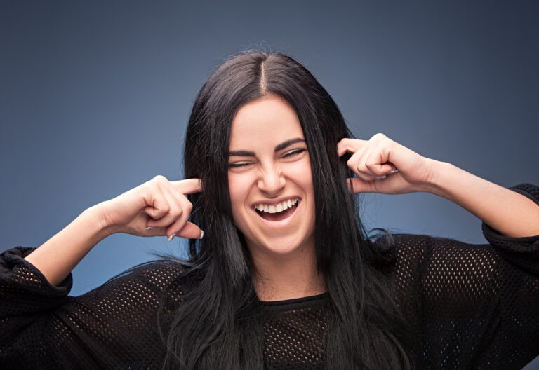 Girl plugging her ears with her fingers