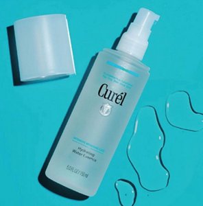 Curél Hydrating Water Essence against a blue background with swatches of product