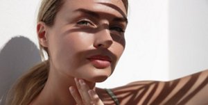 Woman sitting in the sun with some shady areas