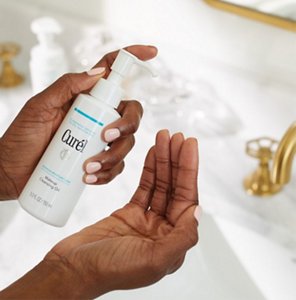 Woman applying oil-based facial cleanser to her hand