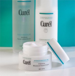 Curél Intensive Moisture Care range on a white worktop against a blue background