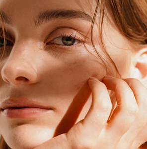 Young redheaded woman with calm, hydrated skin