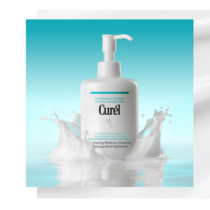 Curél Hydrating Makeup Cleanser surrounded by splashing milky texture