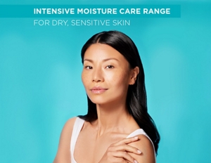 Woman with nourished skin against a teal background