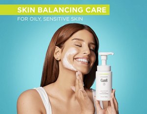 Woman using Curél Oil Control Foaming Facial Wash against a teal background