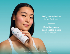 Young woman with radiant, healthy-looking skin holding Curél Resurfacing Micro Mousse Cleanser