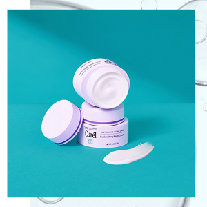 Curél Replenishing Night Cream next to a swatch of cream against a teal background
