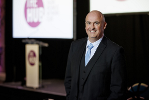 four diverse woman with different hair colors and lenghts, which stand side by side and close to each other looking into the camera while standing in front of a clean grey background