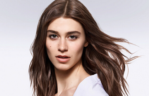 Vrouw met bruin haar voor een lichte achtergrond 