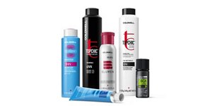 Six bottle of Goldwell product two blue, two black and two white, five standing and one horizontal.