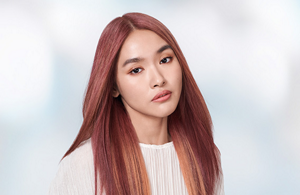 Woman with dark wavy hair in front of bright background and the text Newance Fashion in front