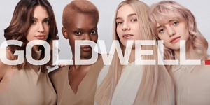four diverse woman with different hair colors and lenghts, which stand side by side and close to each other looking into the camera while standing in front of a clean grey background with the goldwell logo inside the picture