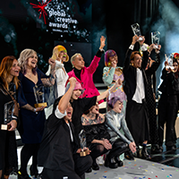 Award winers from Goldwell's Global Creative Awards 2024 celebrate with each other and their trophies on stage