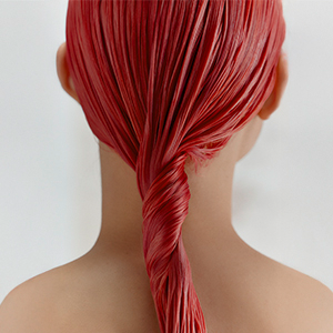 A collage of images showing the Goldwell Color of the Year 2026, Bellini, on real hair, when dry, during the dyeing and when wet.