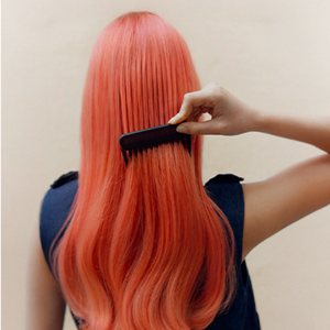 A collage of images showing the Goldwell Color of the Year 2026, Bellini, on real hair, when dry, during the dyeing and when wet.