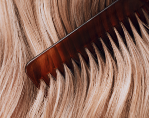 Goldwell Dualsenses PETA module featuring a close-up of blonde hair being combed