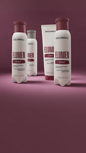 Goldwell Elumen Support and Elumen Care hair bottles displayed on a deep burgundy background.