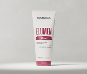 Goldwell Elumen Care packshot showing a white Elumen Conditioner tube standing on a light grey studio background.
