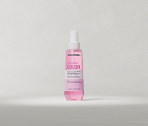 Goldwell Dualsenses Color Spray Serum 150 ml pink bottle standing upright on a soft light grey studio background.