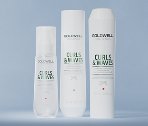 Group shot of Goldwell's Dualsenses Curls & Waves range with Milk Protein to cleanse and hydrate naturally wavy, curly and permed hair. Including Hydrating Shampoo, Hydrating Conditioned and Hydrating Serum Spray