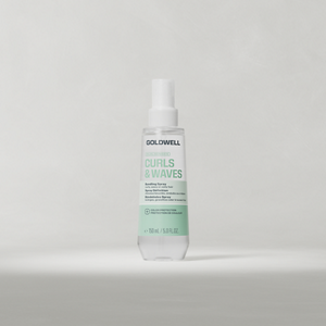Goldwell Dualsenses Curls & Waves Bundling Spray bottle standing upright on a soft light grey studio background.