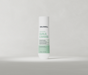 Goldwell Dualsenses Curls & Waves Bundling Shampoo 250 ml bottle standing upright on a soft light grey studio background.